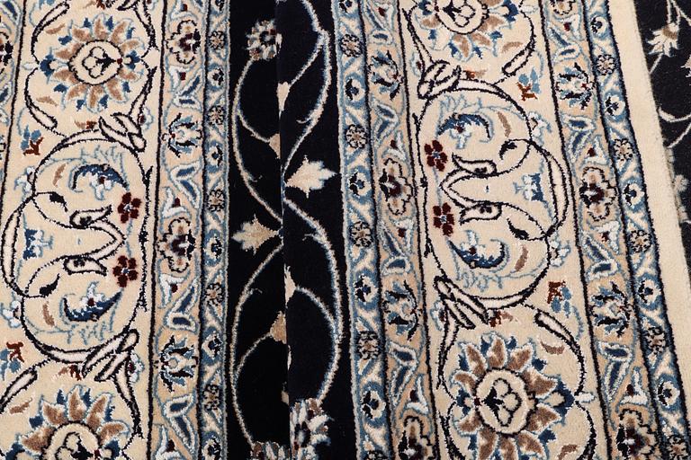 A carpet, Nain, part silk, 9 laa, c.295 x 197 cm.