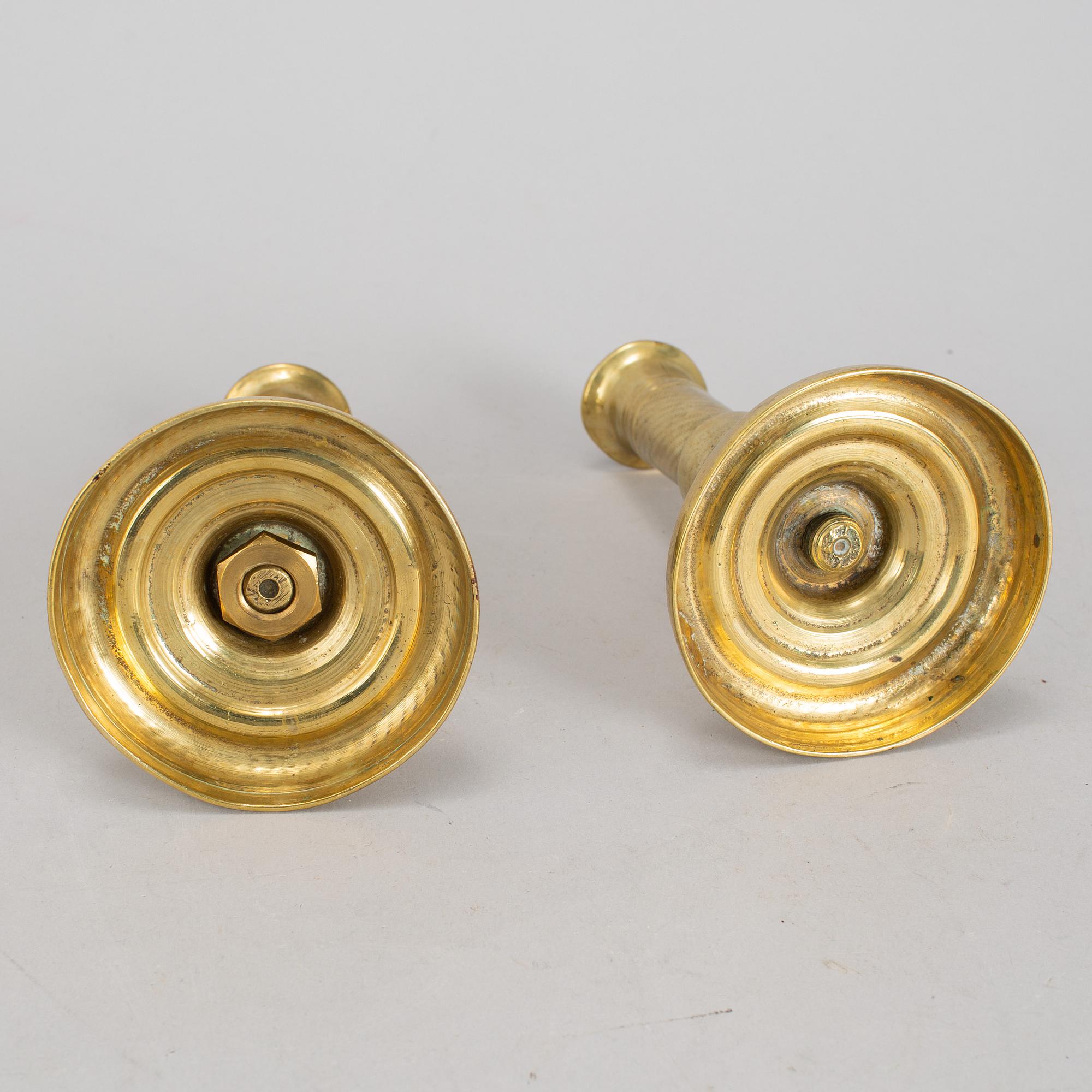 A 19th Century pair of brass candlesticks.
