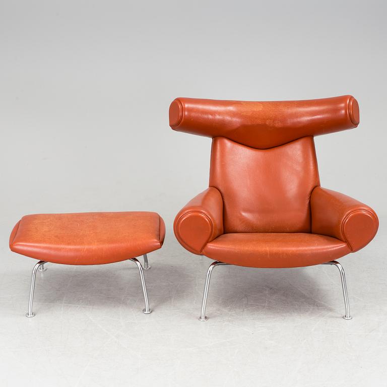 An "Ox-Chair" and foot stool by Hans J Wegner for Erik Jorgensen, Denmark.