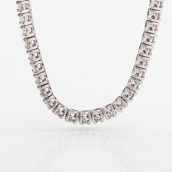 Tenniskaulakoru/-rannekoru, 14K valkokultaa ja timantteja n. 6.96 ct yht. AIG todistuksella.