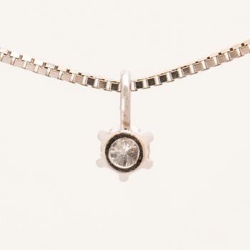 An 18K white gold necklace set with a round brilliant-cut diamond.