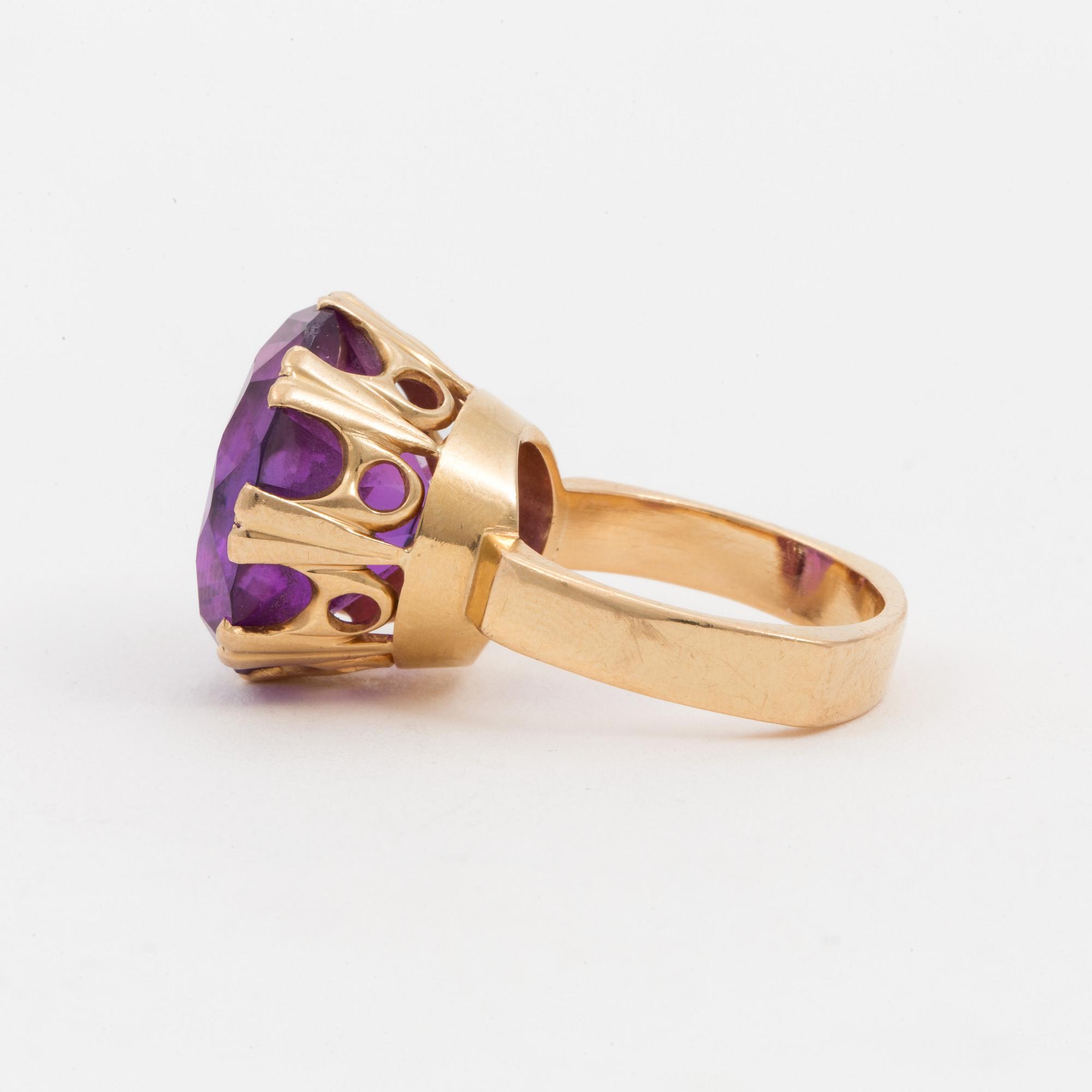 A ring set with a synthetic, purple sapphire.