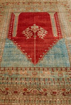 A RUG, an antique silk Tabriz, ca 165 x 122,5 cm.