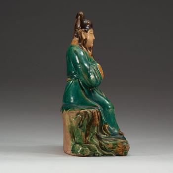 A green and yellow glazed figure of a seated deity, Ming dynasty (1368-1644).