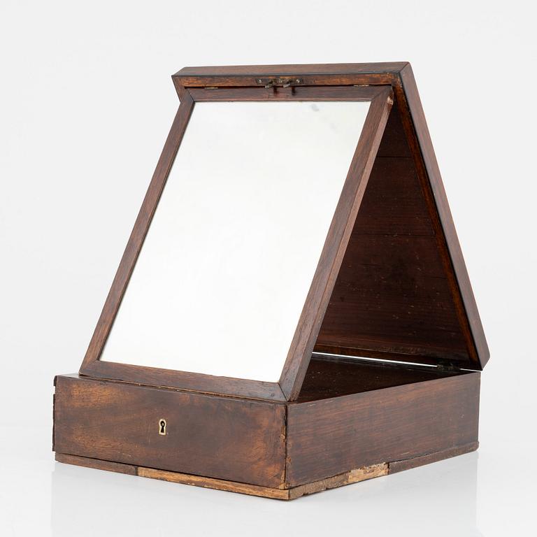 An early 19th century mahogny-veneered box for shaving utensils.