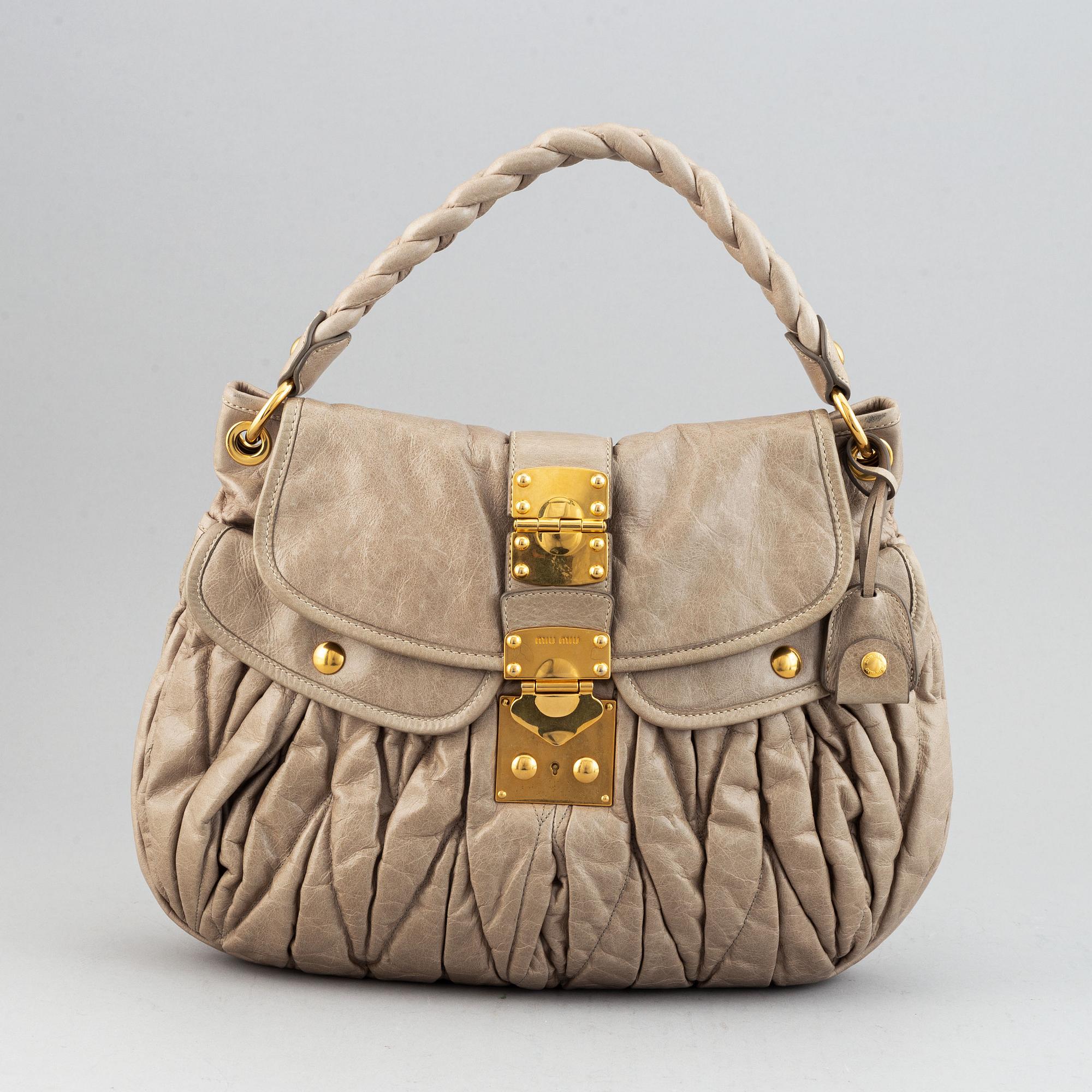 Miu Miu, a light leather handbag.