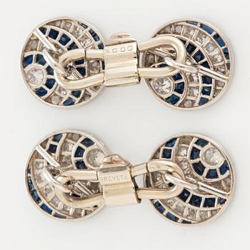 A pair of cufflinks in platinum and 18K white gold set with diamonds of various cuts and sapphires.