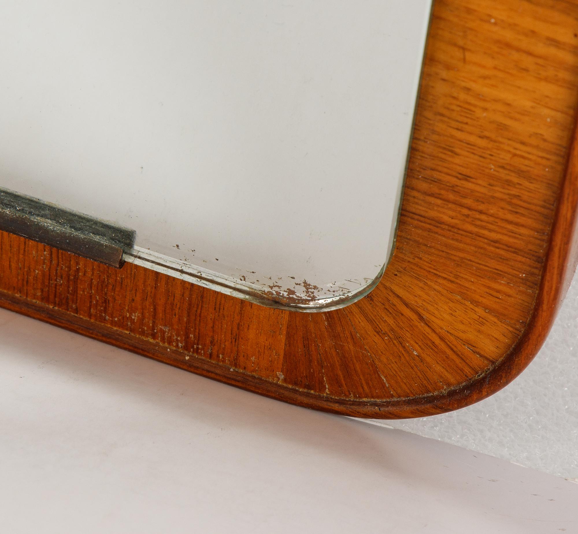 A teak mirror, mid 20th century.