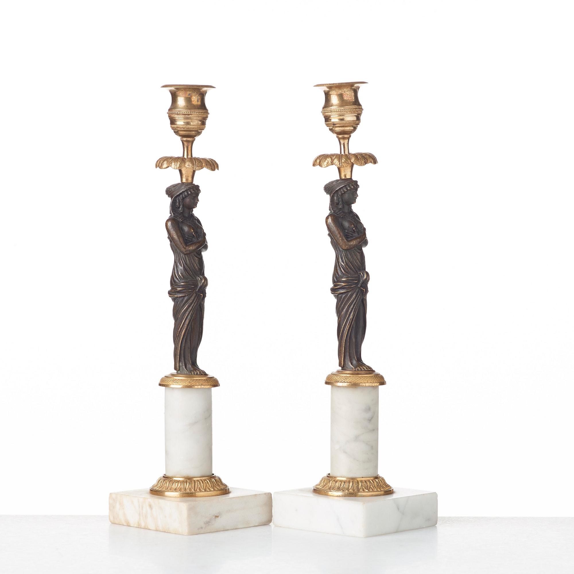 A pair of late Gustavian circa 1800 white marble and bronze candlesticks.