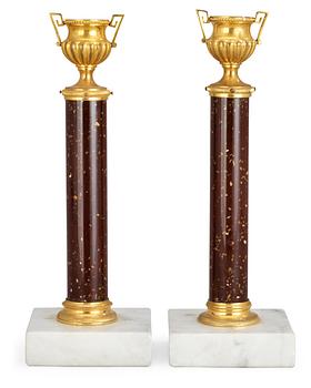 613. A pair of Swedish 19th century candlesticks, glas imitating porphyry.