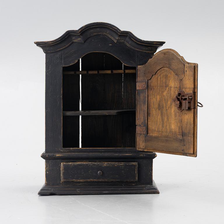 A Baroque wall cabinet, 18th Century.