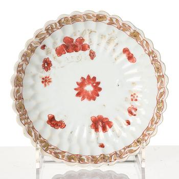 A Chinese iron red porcelain cup with saucer and a small famille verte dish, Qing dynasty, Kangxi (1662-1722).