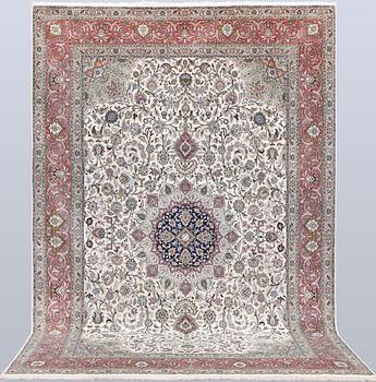 A part silk Tabriz carpet, 310 x 205 cm.