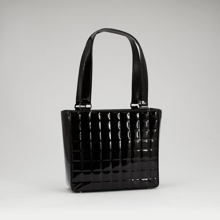 CHANEL, a quilted black patent leather top handle bag.