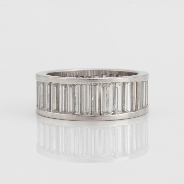 AN ETERNITY RING set with baguette-cut diamonds of graduated sizes.