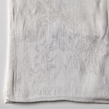 A TABLE CLOTH AND NAPKINS, 24 pieces, linen damask, the table cloth is dated 1827, ca 560-567 x 207,5 cm, Sweden 1827.