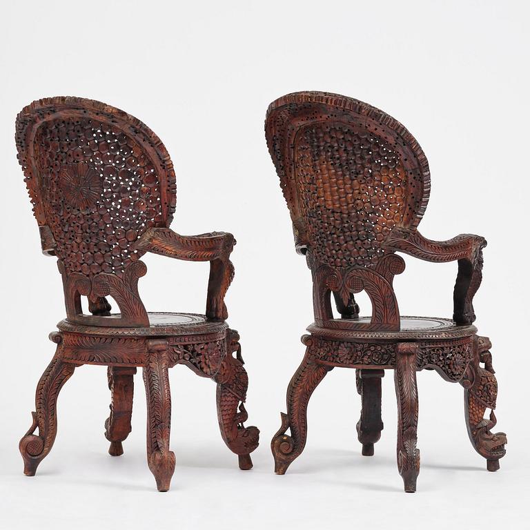 A pair of carved 'blackwood' armchairs, Bombay presidency, British Raj, circa 1880.