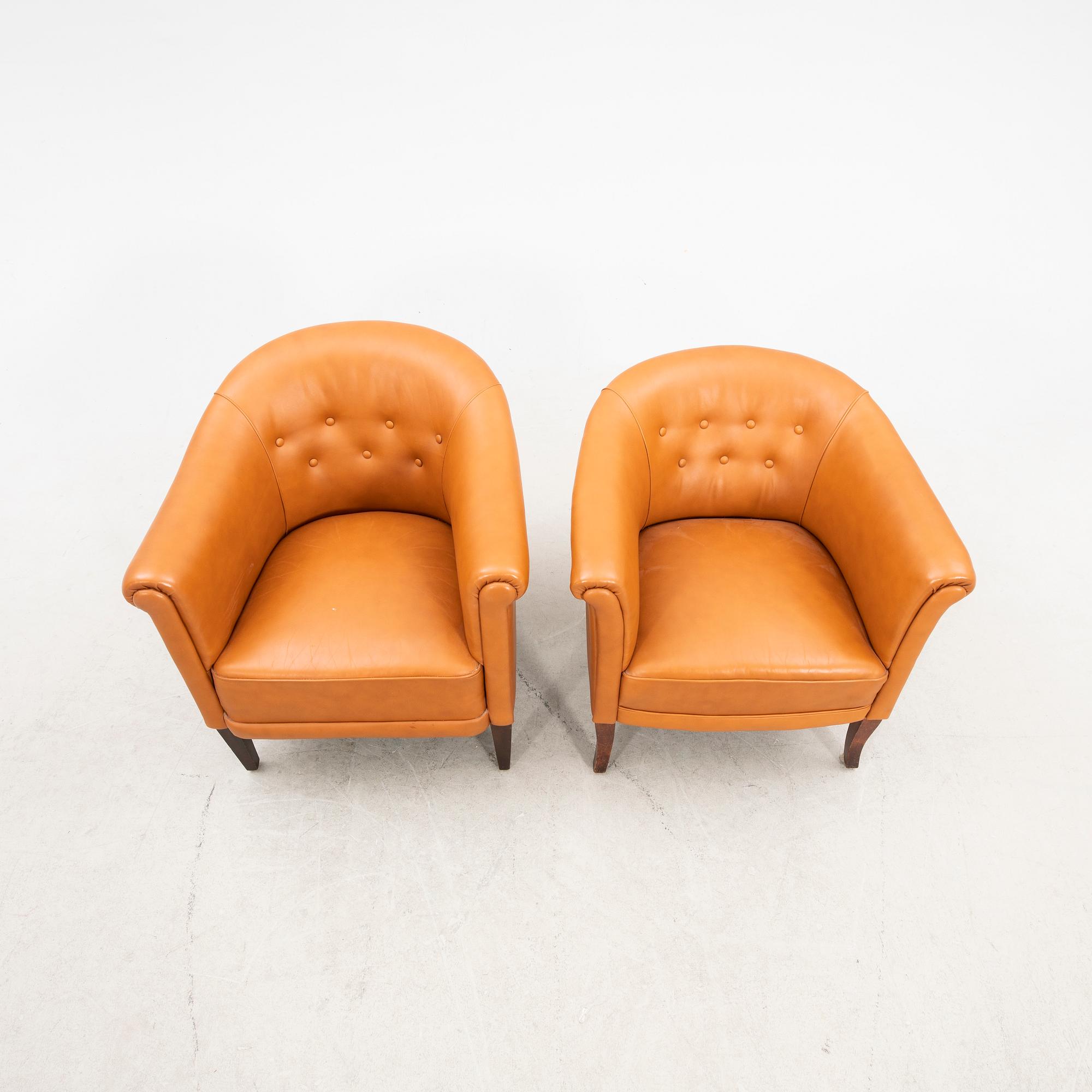 A set of two  1940s leather armchairs.