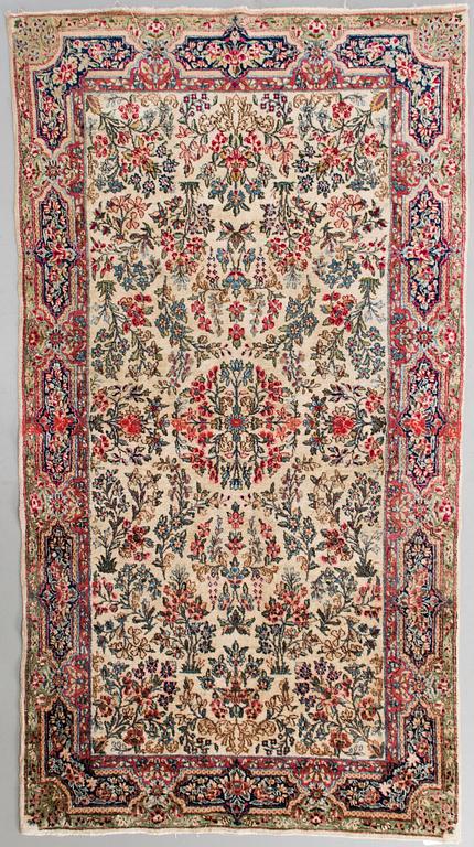 An old Kirman rug. Circa 230X125 cm.