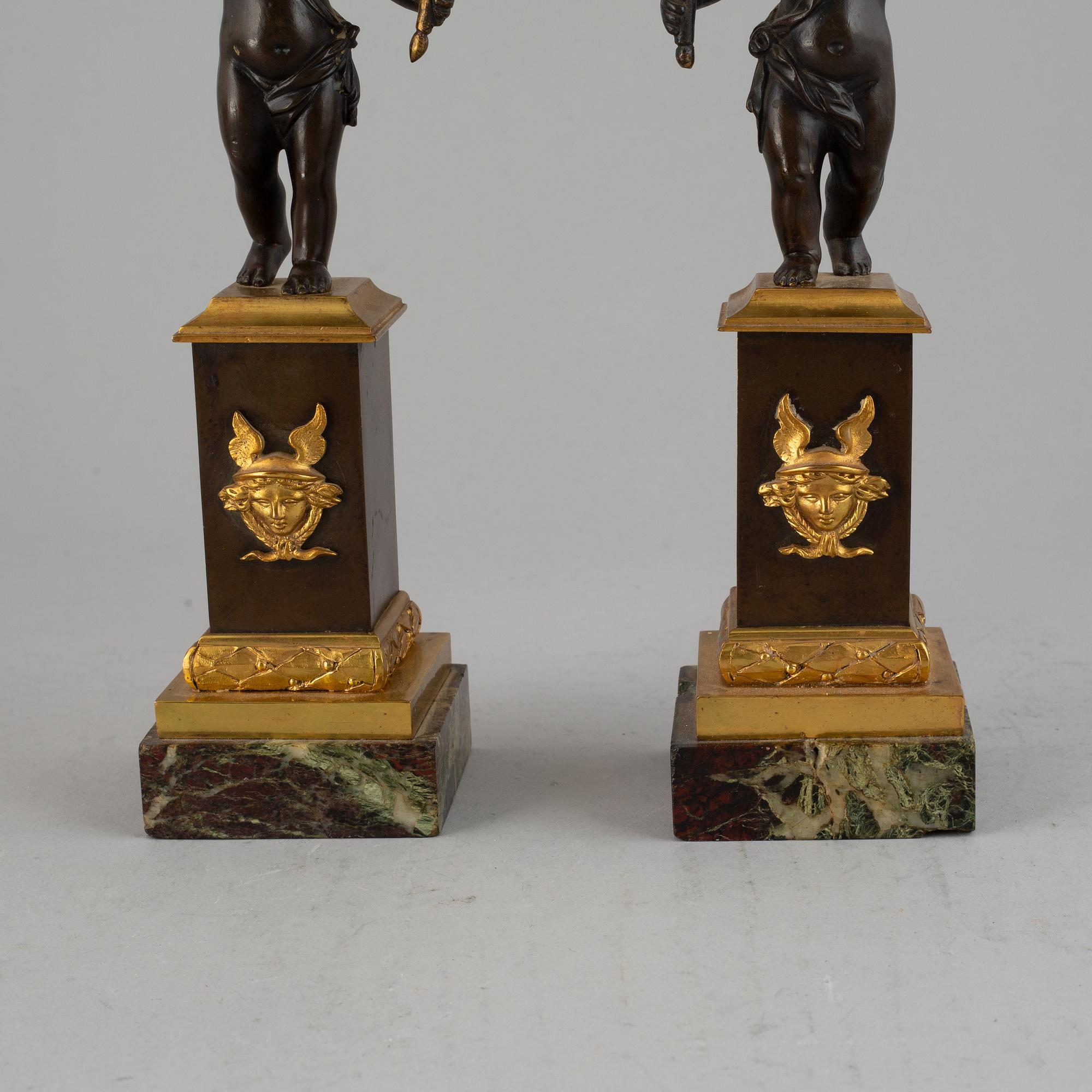 A pair of bronze empire style candleabra, 20th century.