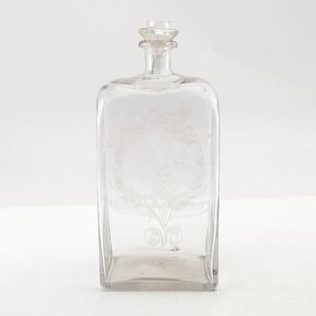 Brännvinsflaska, glas. Daterad Broby 1856.