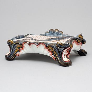 A new rococo creamware bracket clock, after Meissen model, early 20th century.