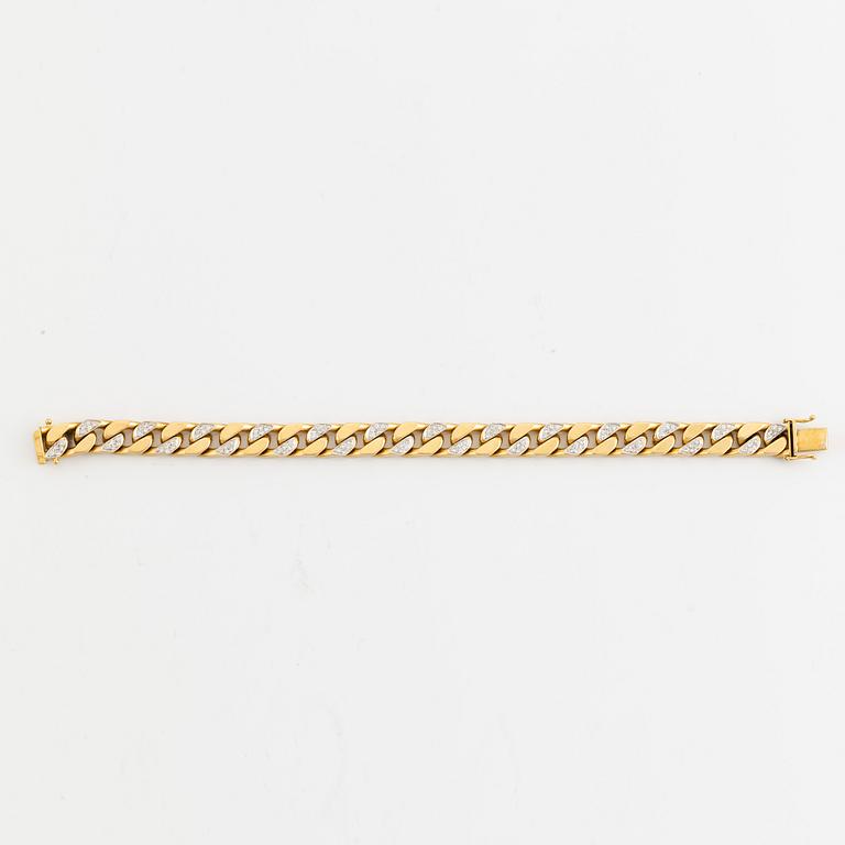 18K gold and brilliant cut diamond curb link bracelet.