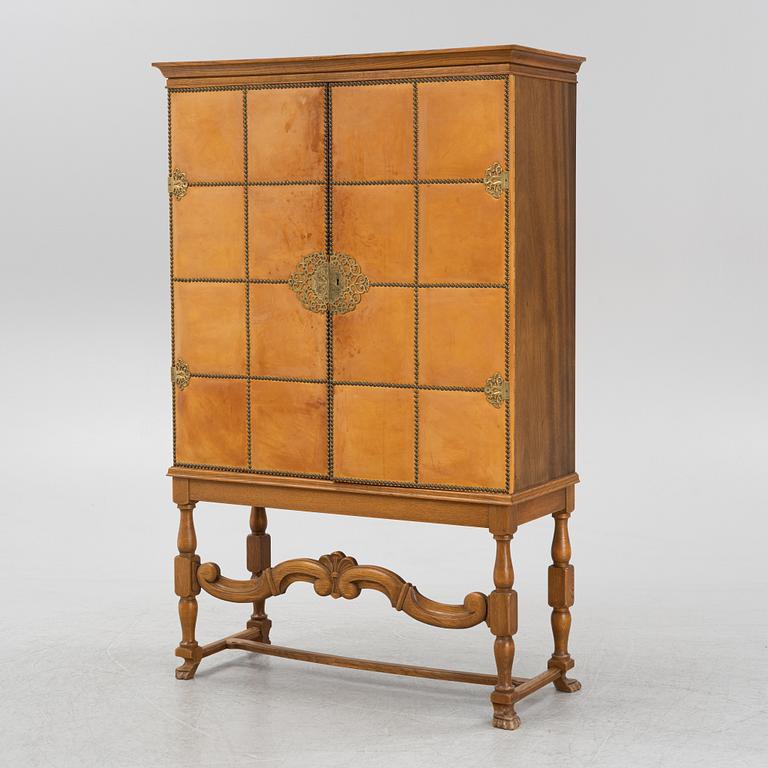 A leather, oak and mahogany cabinet, mid 20th Century.
