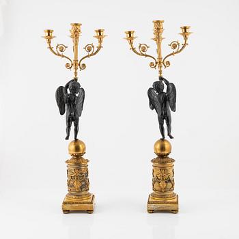 A pair of Empire-style ormolu and marble four-light candelabra, late 19th century.