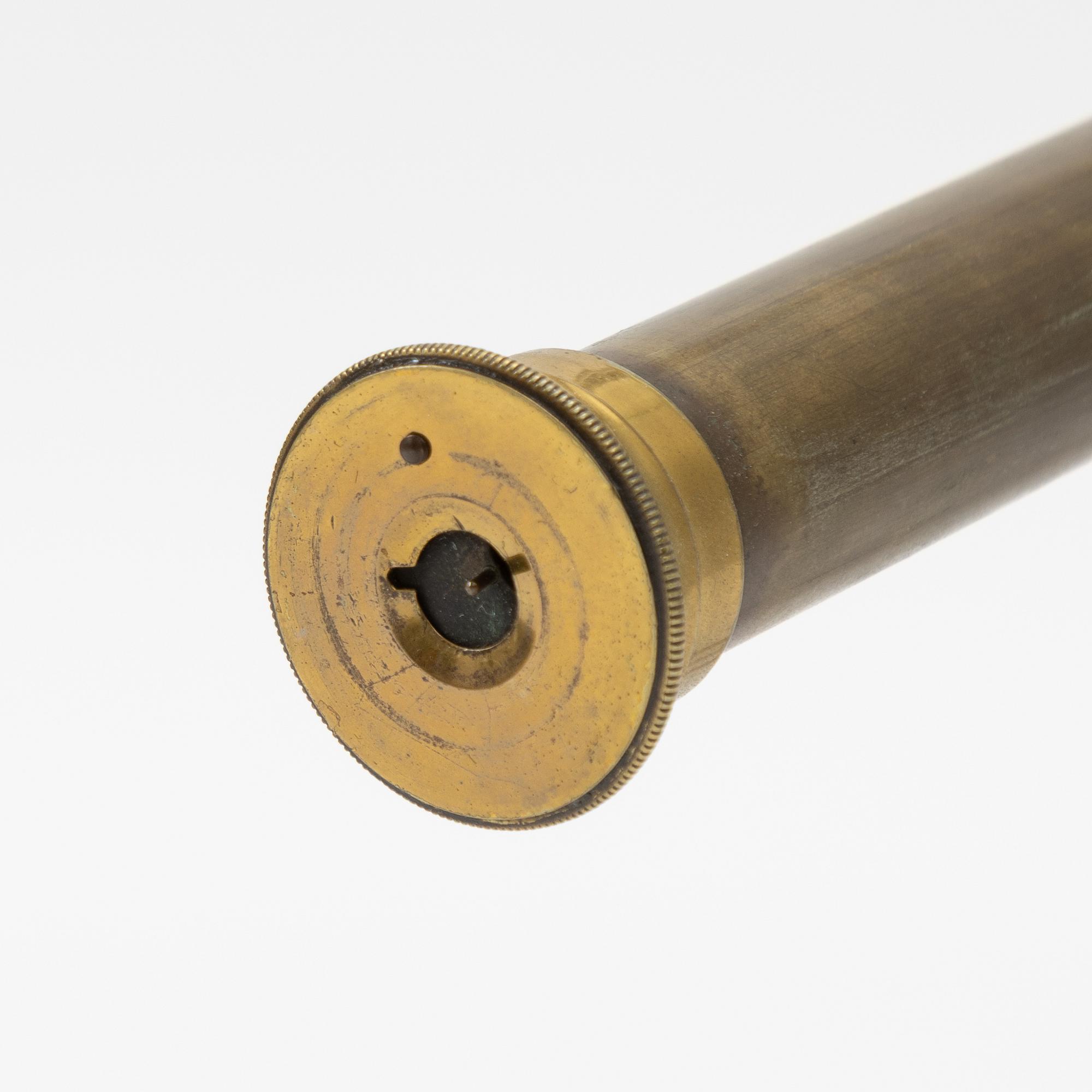 A telescope on a tripod, 19th/20th century.