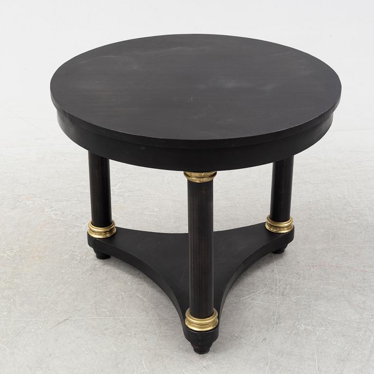 A contemporary empire style sheet metal center table.