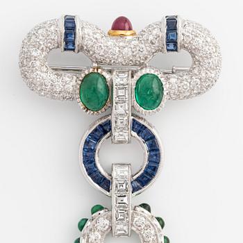 Brooch, white gold with cabochon-cut emeralds, rubies, sapphires, and brilliant- and square-cut diamonds.