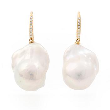 A pair of earrings with cultured baroque-shaped freshwater pearls and round brilliant-cut diamonds.