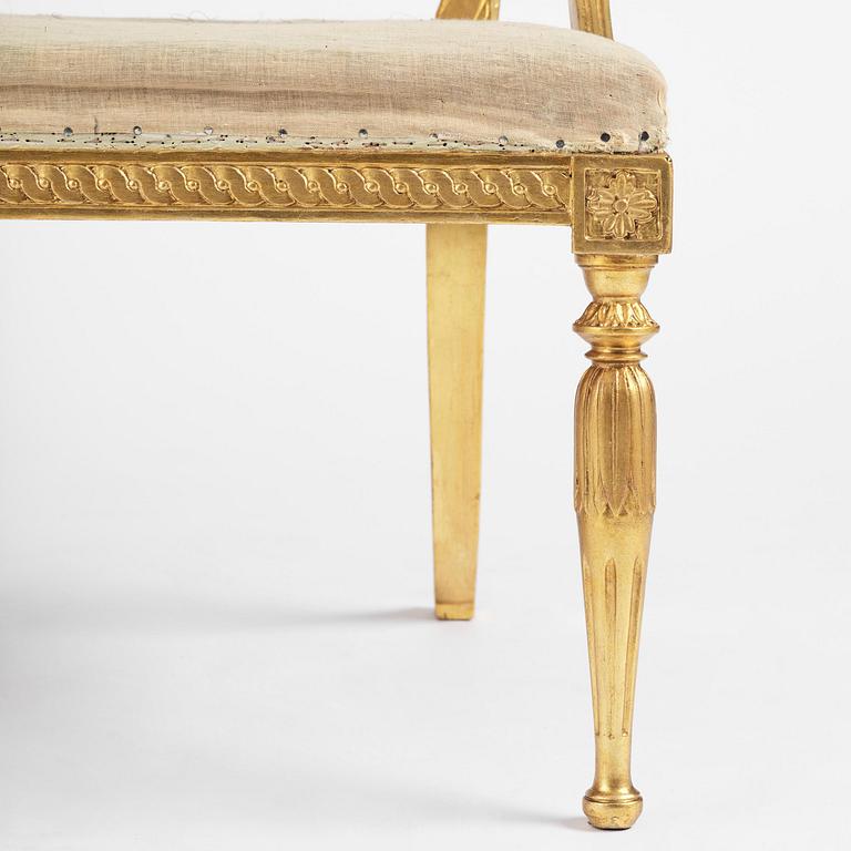 A pair of late Gustavian giltwood open-back armchairs, Stockholm, late 18th century.