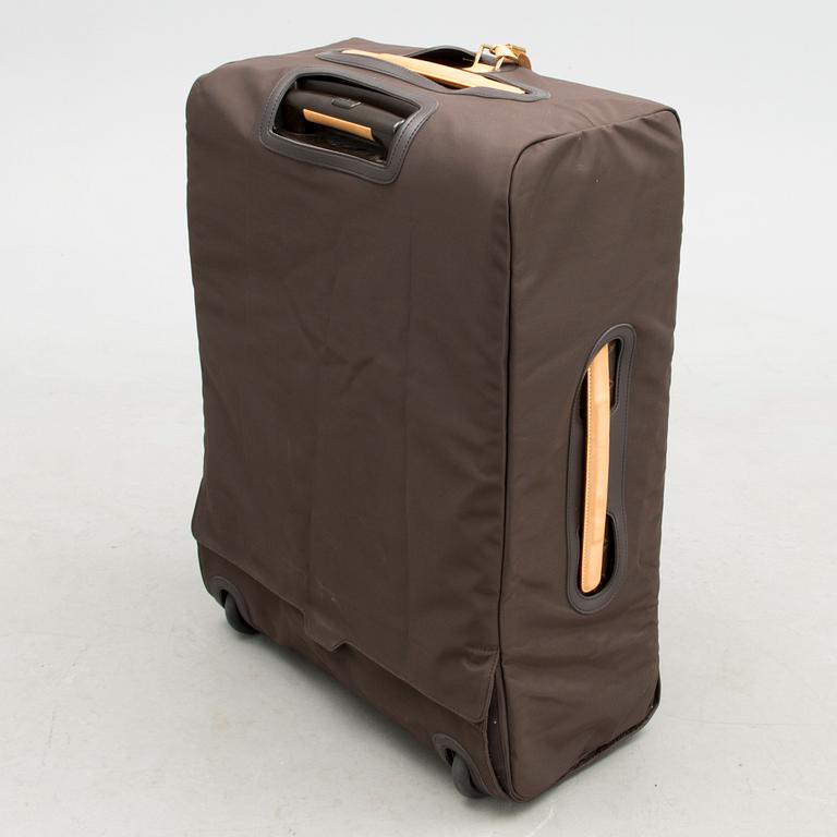 A Monogram Canvas Pégase 65 Suitcase with a Protective Cover.