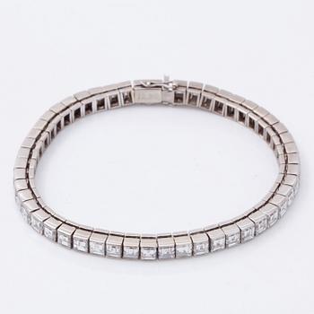 A square step-cut diamond line bracelet. Total carat weight 12.80 cts.