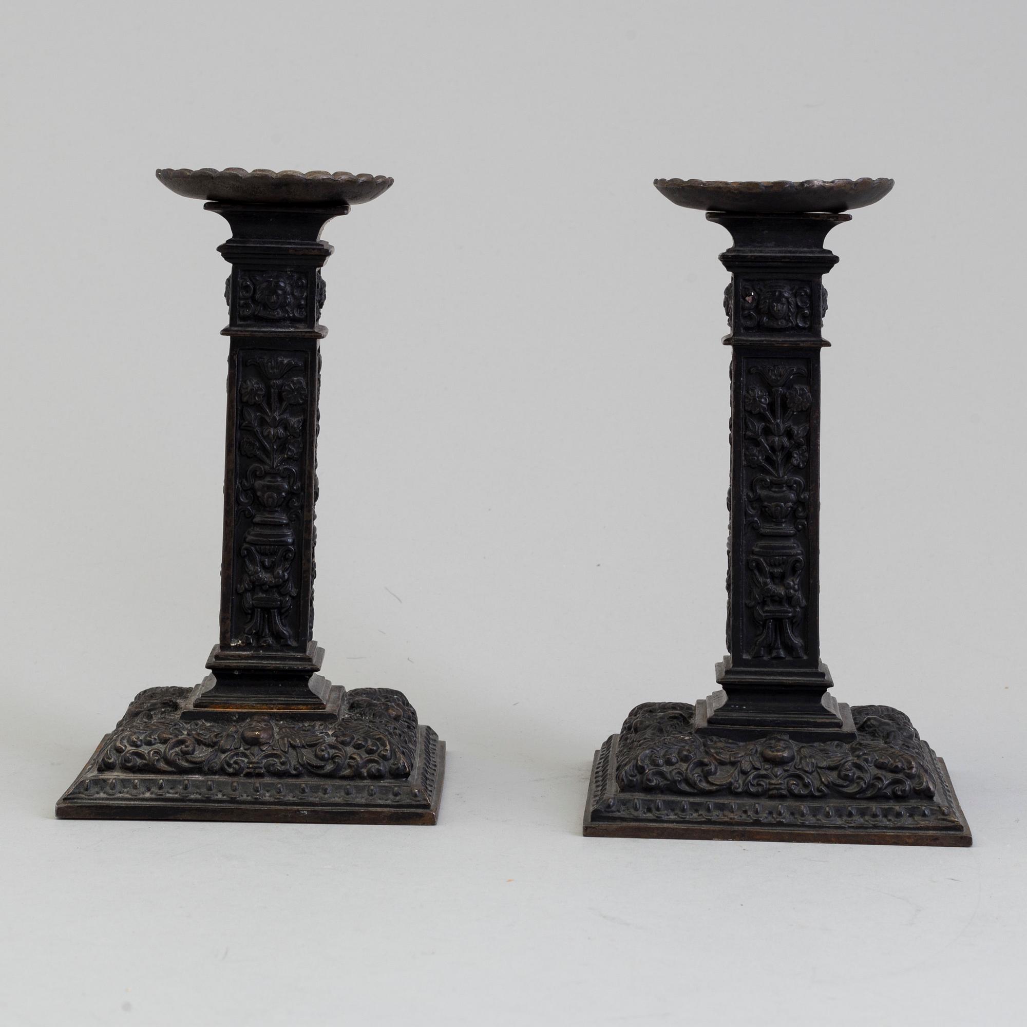 A PAIR OF 1907 RUSSIAN IRON CANDLESTICKS BY M TAROKIJ.