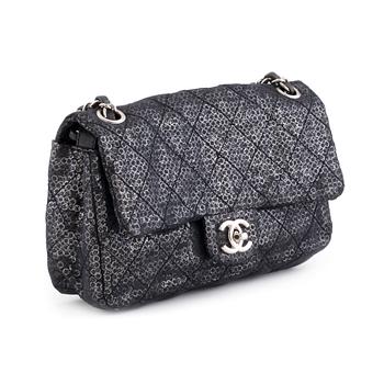 550. CHANEL, a black and silver tinsel evening "Flap-bag".
