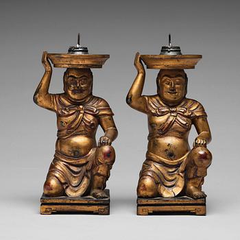 680. A pair of gilt lacquered candle holders, late Qing dynasty.