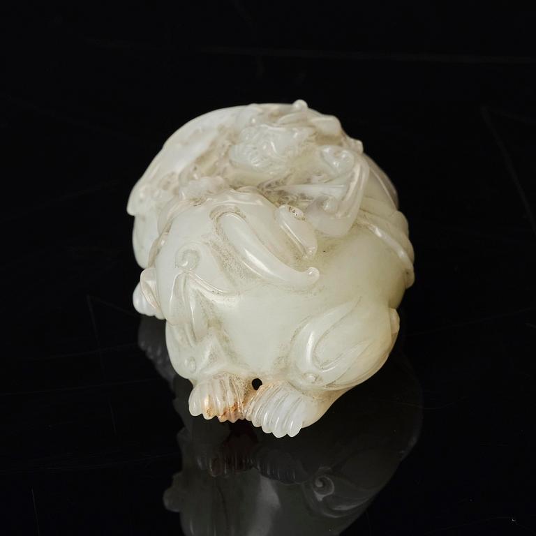 A Chinese nephrite carving of a recumbant lion with her cub, Qing dynasty.