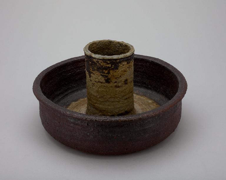 A CERAMIC CANDLESTICK.