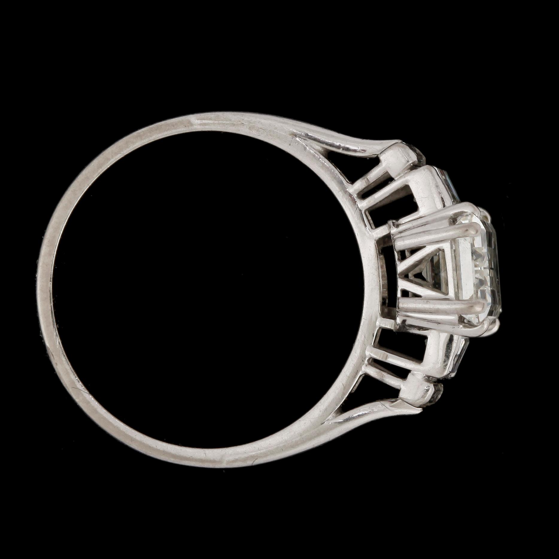 An emerald cut diamond ring, app. 2.40 cts, and smaller, tot. app. 0.50 cts.