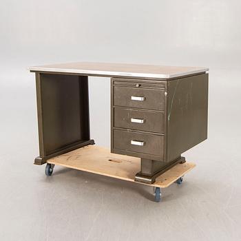 An 1950:s industrial metal and linoleum writing desk.