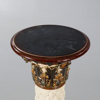 A Rörstrand pedestal with pot in majolica, made around year 1900.