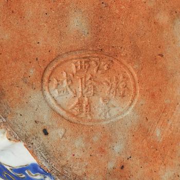 A large famille rose porcelain figure of a buddha with children, 20th century.