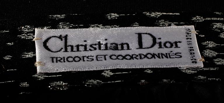 An ensemble consisting of skirt, top, belt and scarf by Christian Dior.