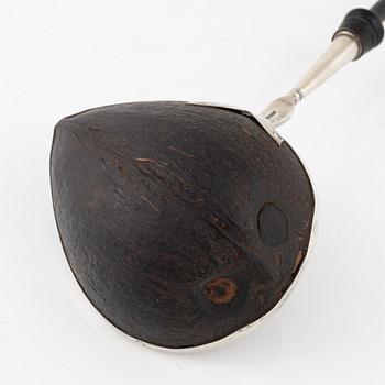 A silver mounted soup ladle with a coconut cup.