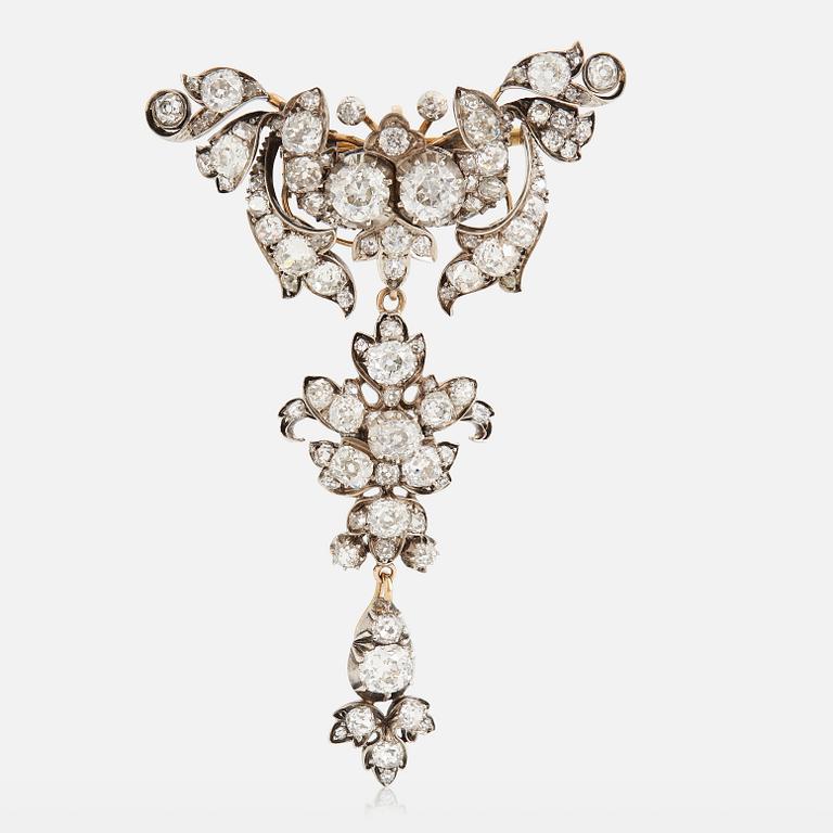 A 14K gold and silver brooch set with old-cut diamonds.