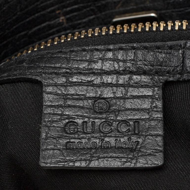 GUCCI, a black canvas and leather bag.