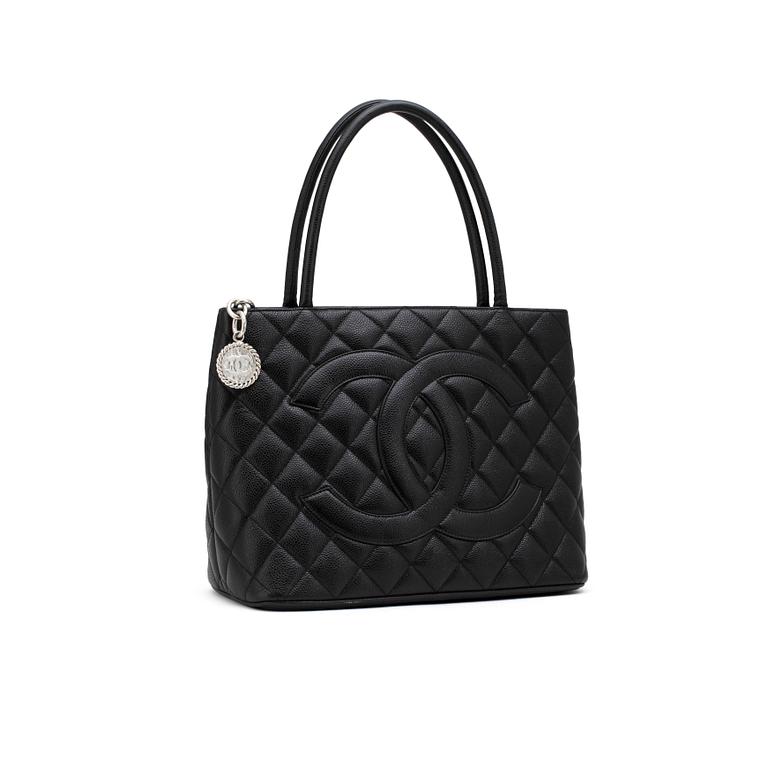 CHANEL, a black leather "Shopping" handbag.